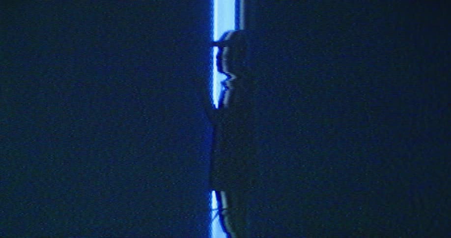 A man is standing in a room and wearing a hat