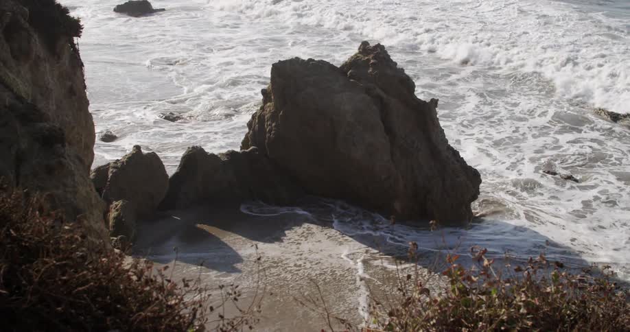 A large rock on the coast as the tide comes in