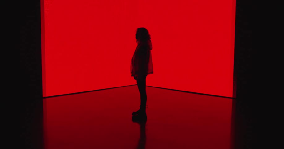 A person standing in a red room