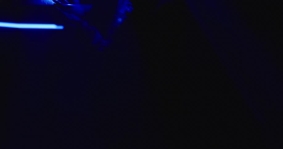 A man is standing in a room with flashing lights