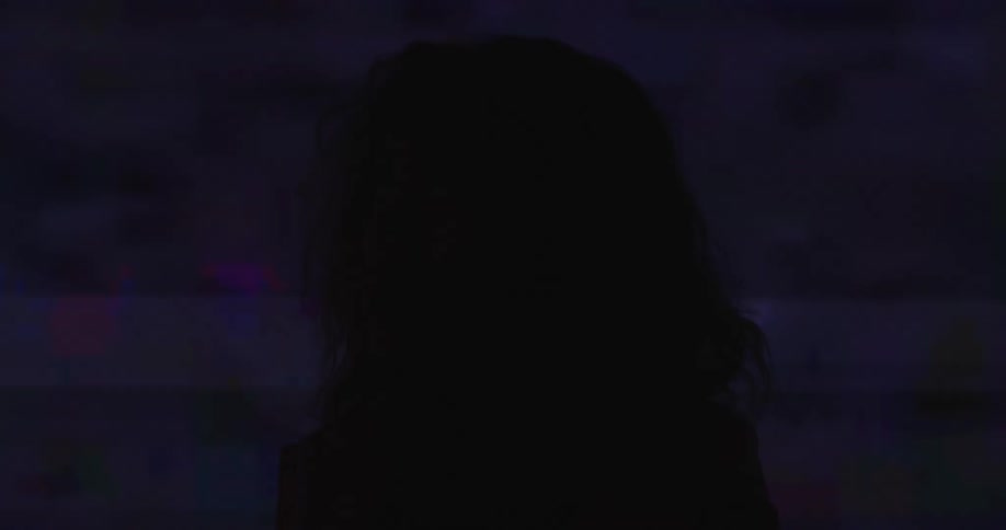 A woman is standing in front of a static filled wall