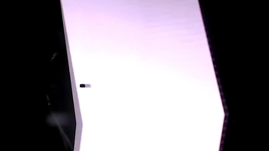 A man wearing a hat is in the dark