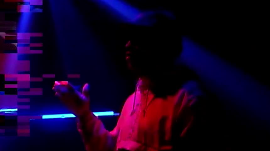 Digital effects on image of man standing on stage under lights at club twirling drum stick
