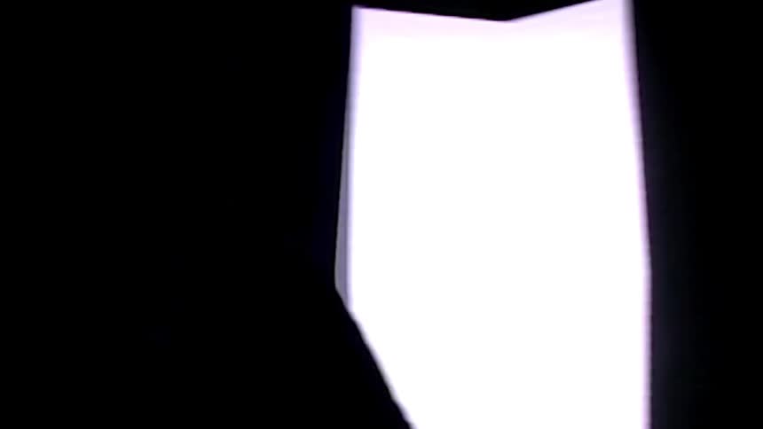 A person wearing a hat is walking around a room