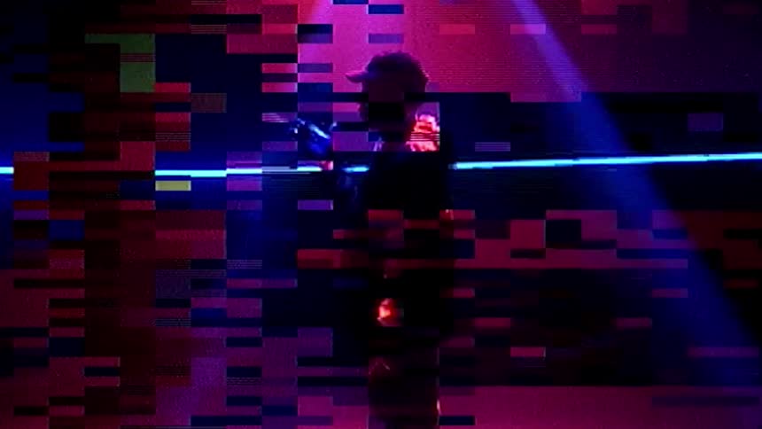 A musician is spinning his drum stick under the flashing lights