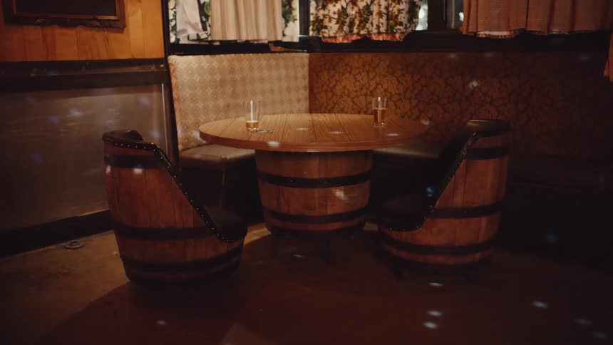 Lights shining on a barrel table and chairs in a restaurant