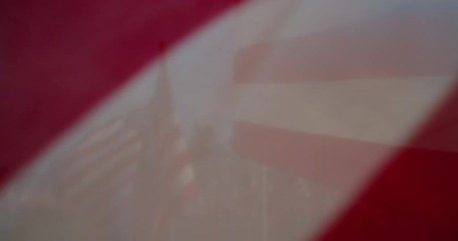 American flags are scattered across an open field