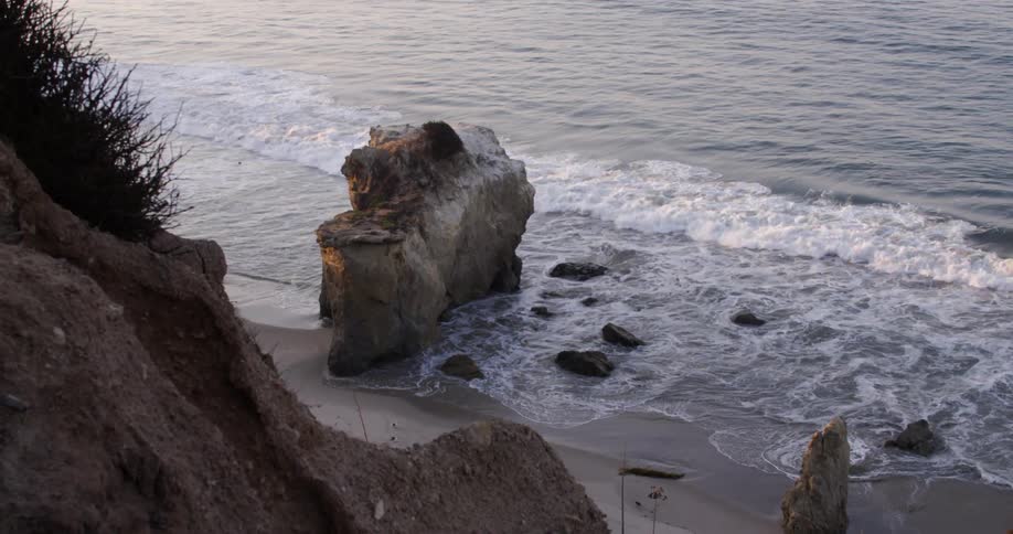 Waves crash against a beach