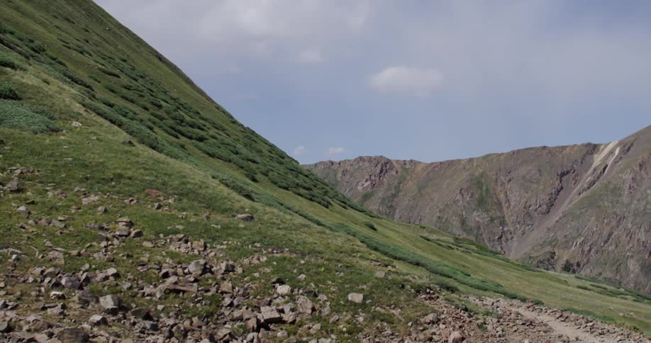 Hills are covered with grass on a cloudy day
