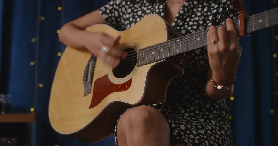 A woman playing a guitar on a stage