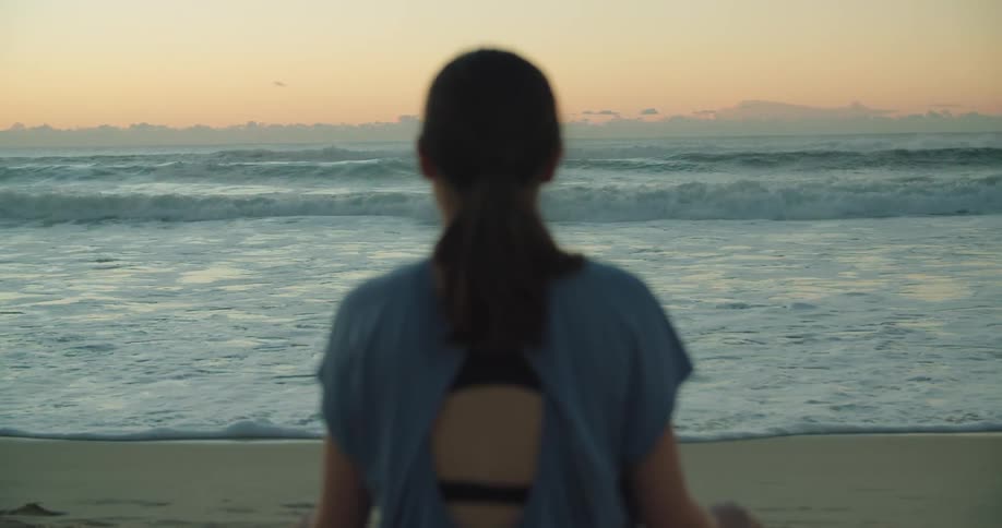A woman is standing and watching the beach