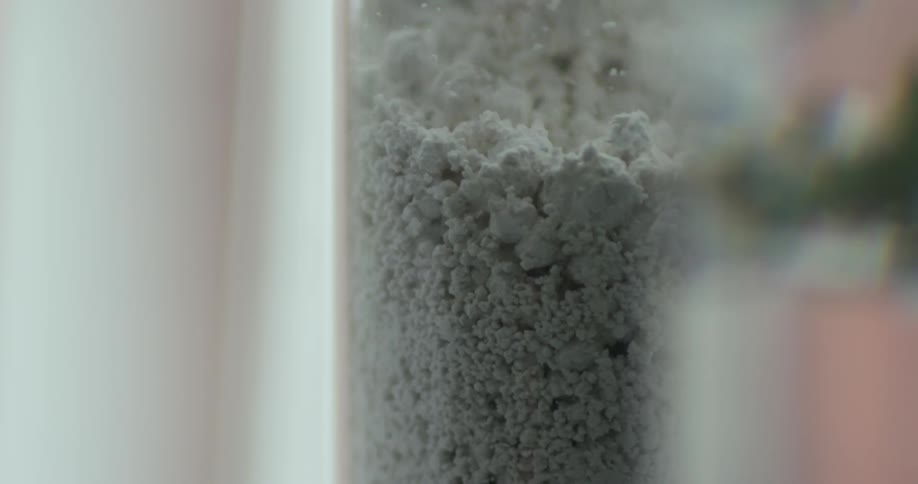 Dust falling in a tube in a room