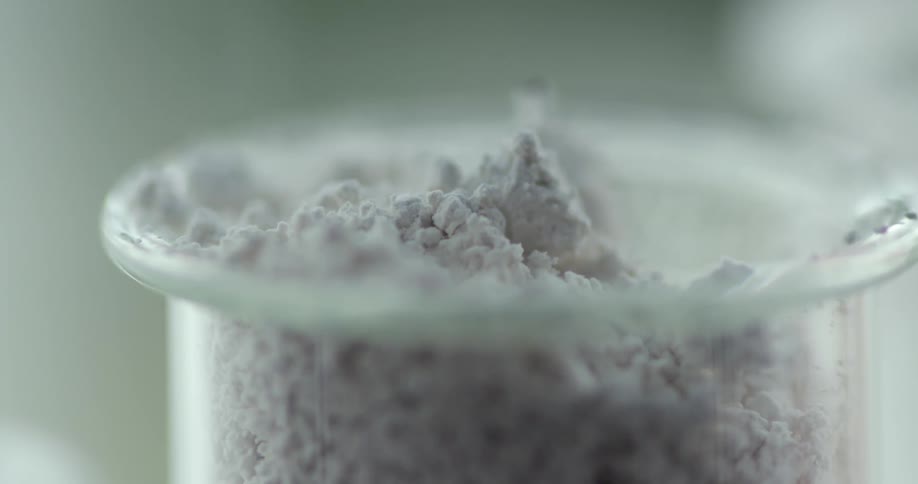 Powder being dropped in to a glass bowl