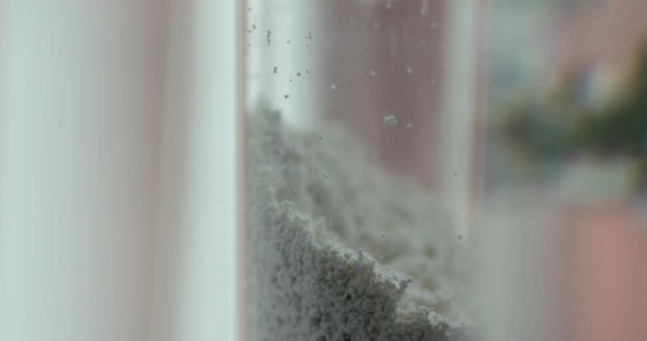 Dust falling in a tube in a room