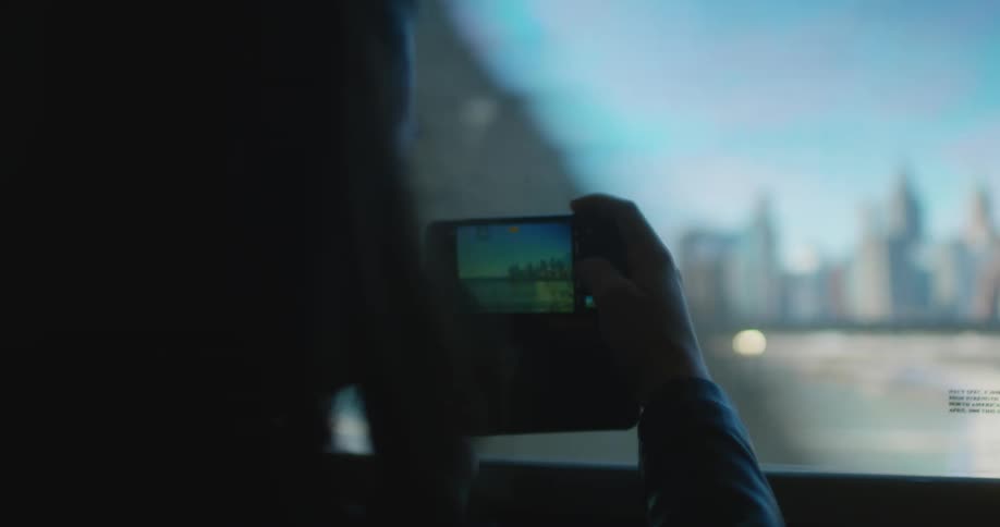 A woman takes a photo of the city as she is traveling
