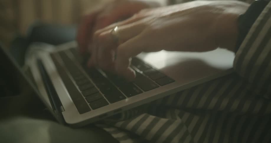 A person is typing on the laptop