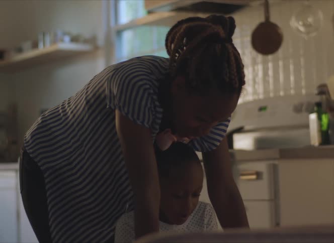 A woman and her child in a kitchen