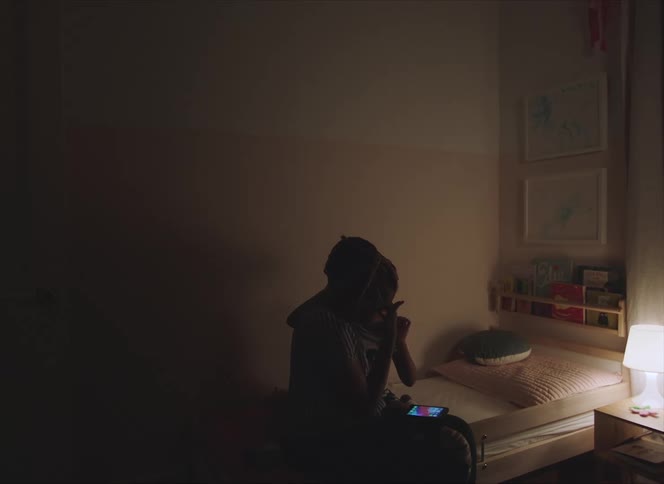 Mother hugging her daughter on the bed at home