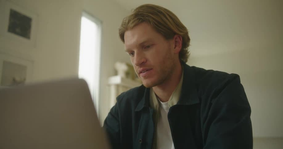 A man talking to people on a laptop