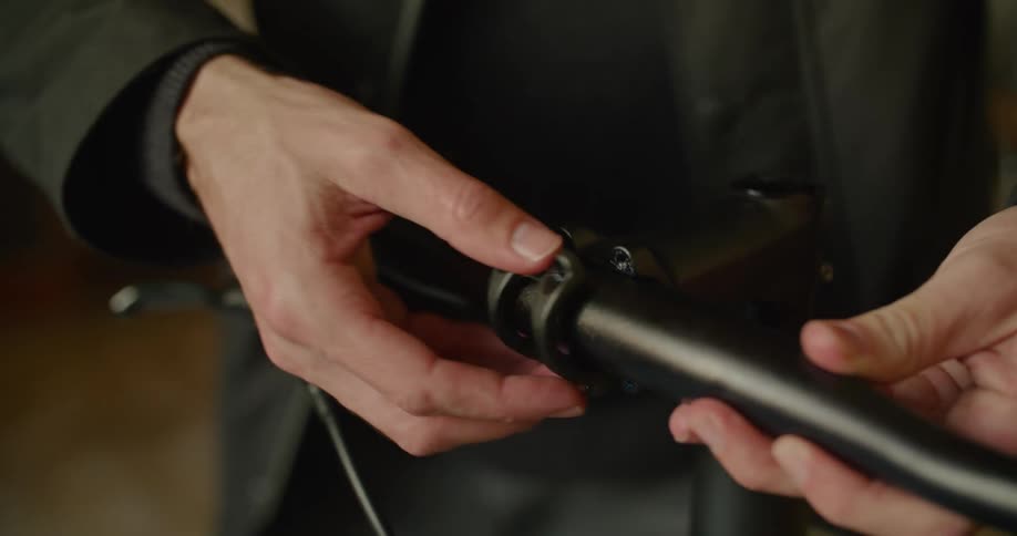 A person securing a metal clip