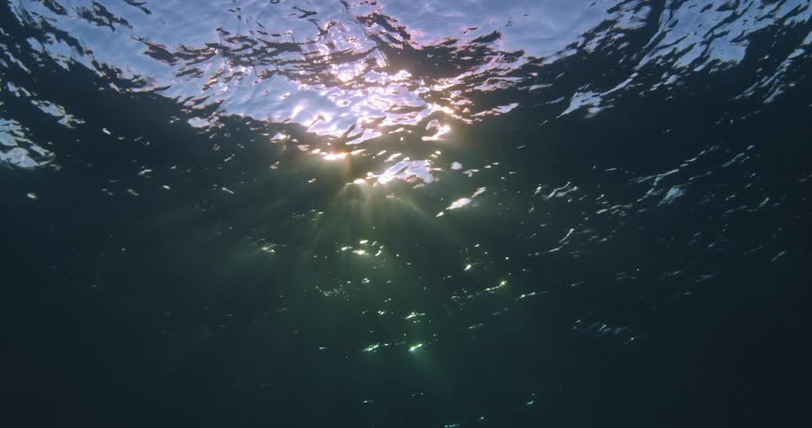The sun casts shadows and light into the ocean
