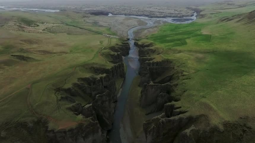 A river flowing through a grassy mountain