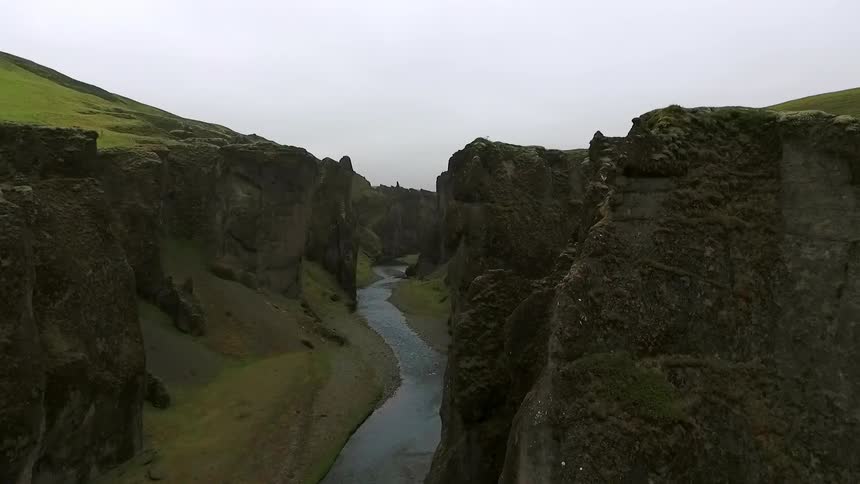 Aerial view of a river in a green canyon