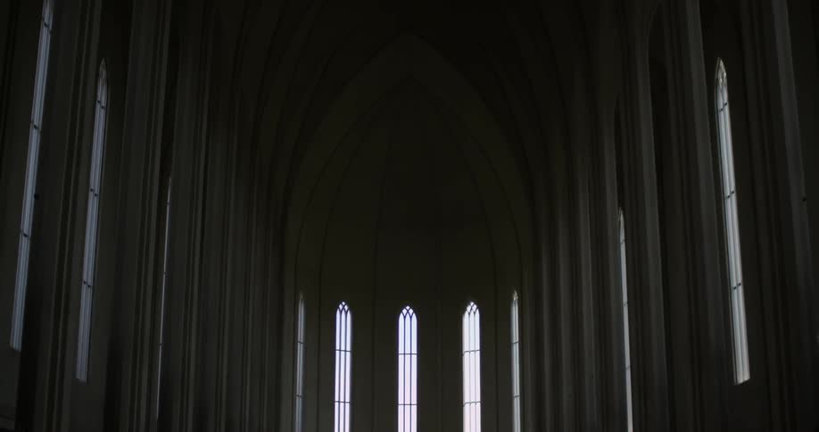 A church is dark with many windows