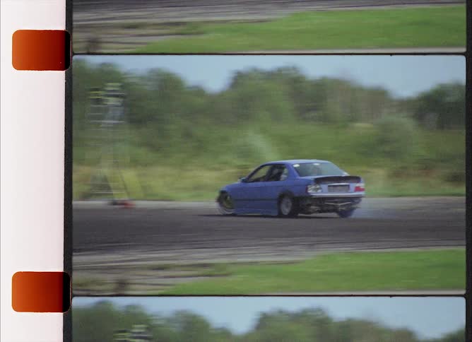 Used car drifting on a race track in the countryside