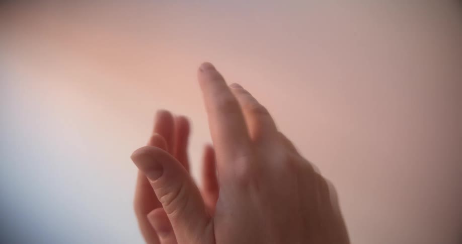 Hands held up turning with fingers outstretched