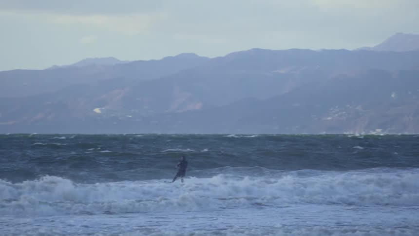 A man kiteboarding in the ocean