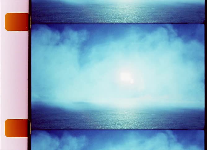 A filmstrip with clouds over the landscape