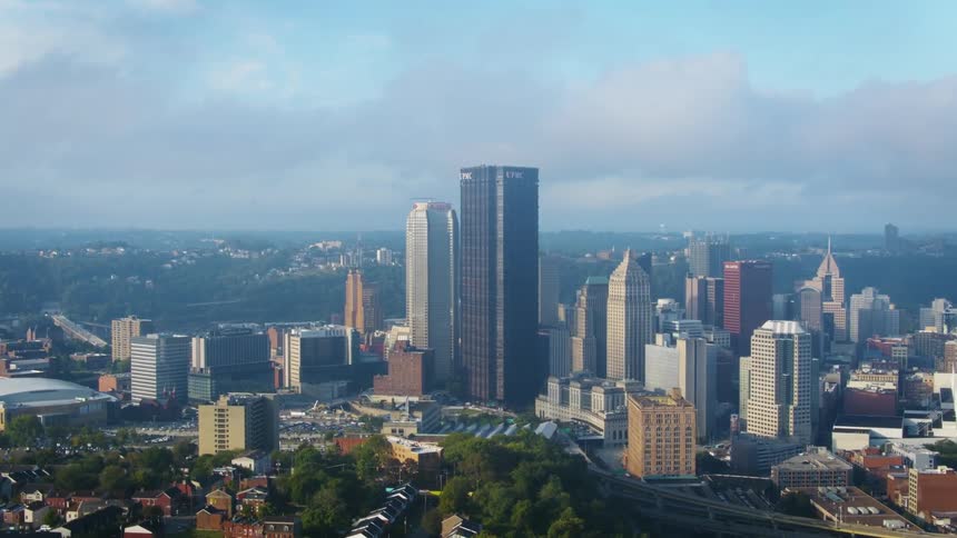 Aerial shot of a city skyline with multiple buildings in sight