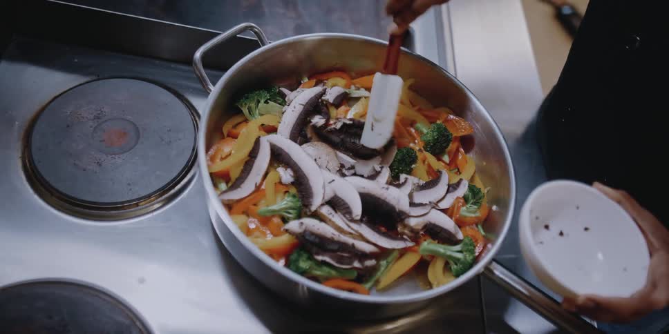 A person cooking on a stovetop
