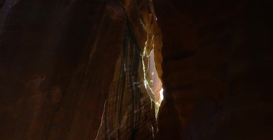 Sunlight filters through a narrow canyon