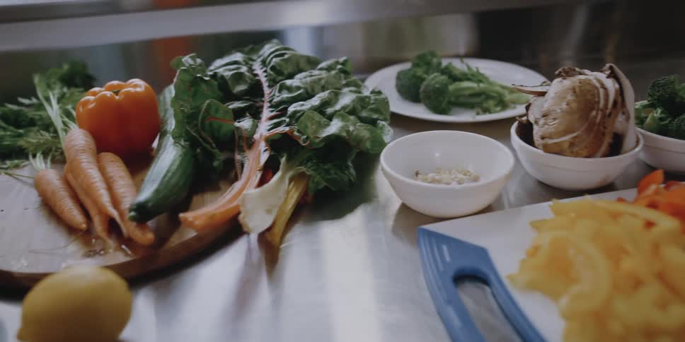 Different vegetables and ingredients cover the counter