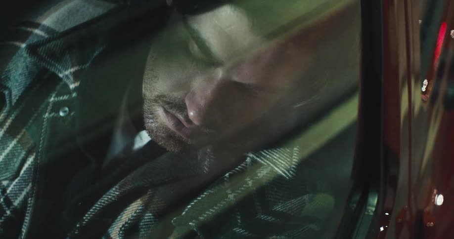 A man sleeping in a car
