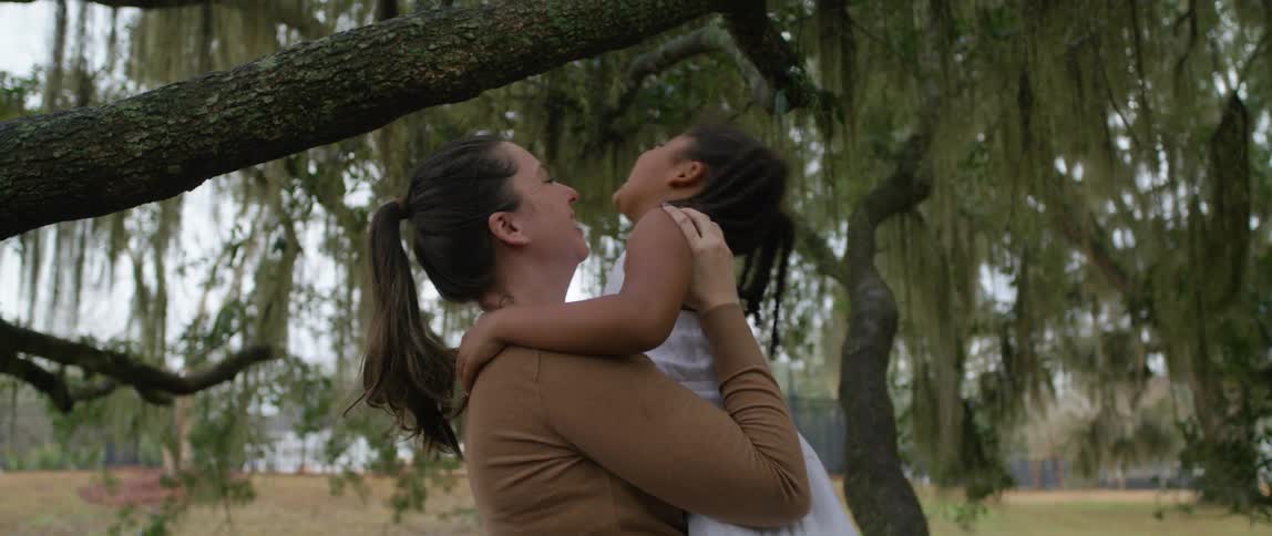 A mother and daughter playing in a park