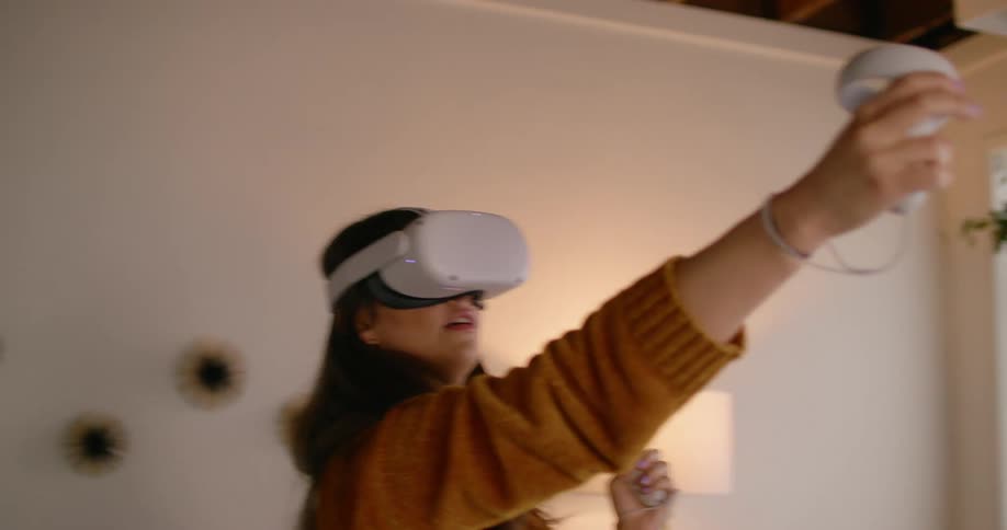 A woman is playing a virtual reality game indoors