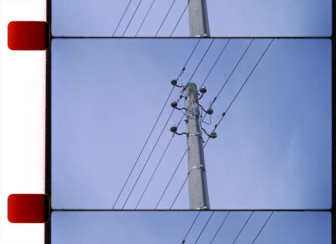 A tall power line is in the blue sky