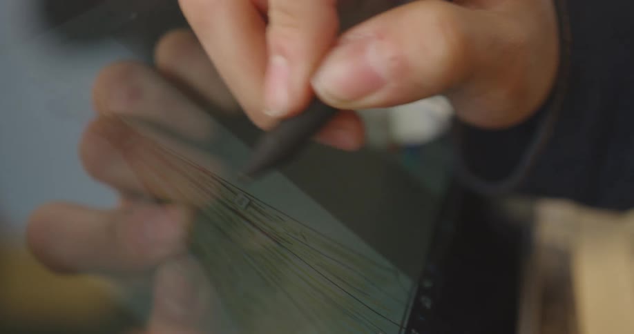 An artist draws an image on a tablet with a stylus