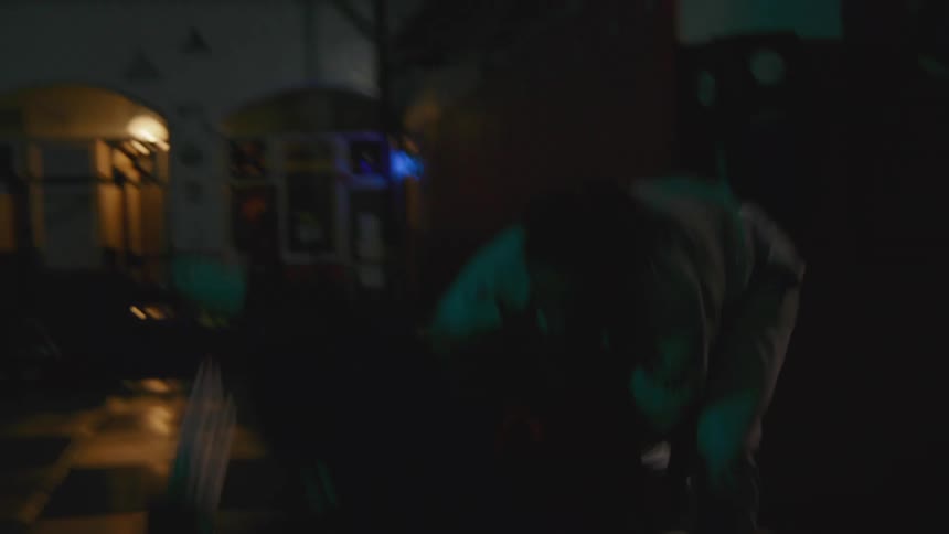 Two men in a room on a mat practicing martial arts with gi and belts