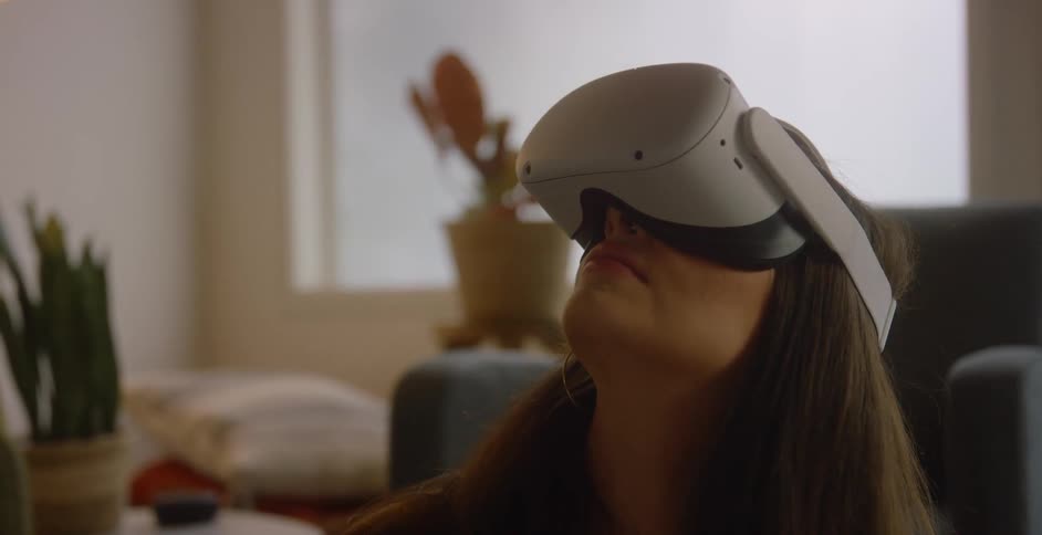 A girl is looking up while wearing virtual reality goggles