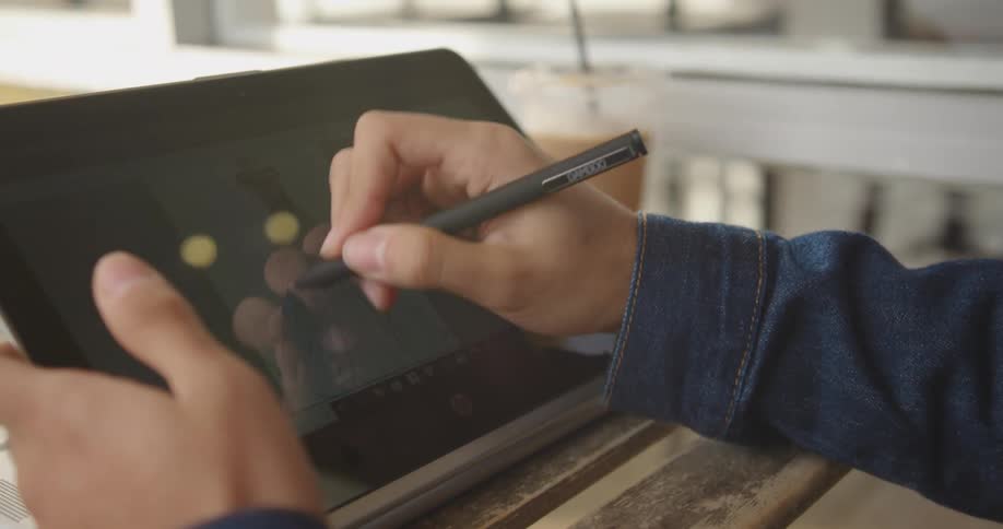 A person is drawing on a tablet