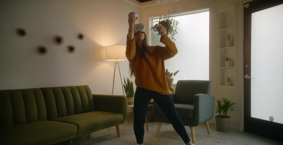 A woman is playing a virtual reality game indoors