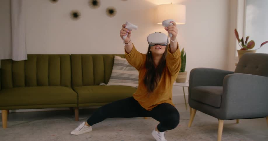 A woman is moving around using virtual reality