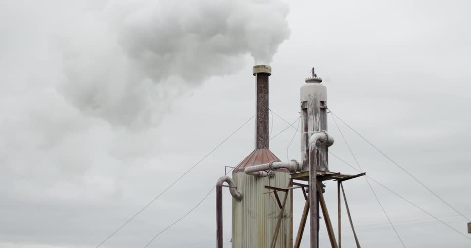 Smoke billowing from an industrial smokestack