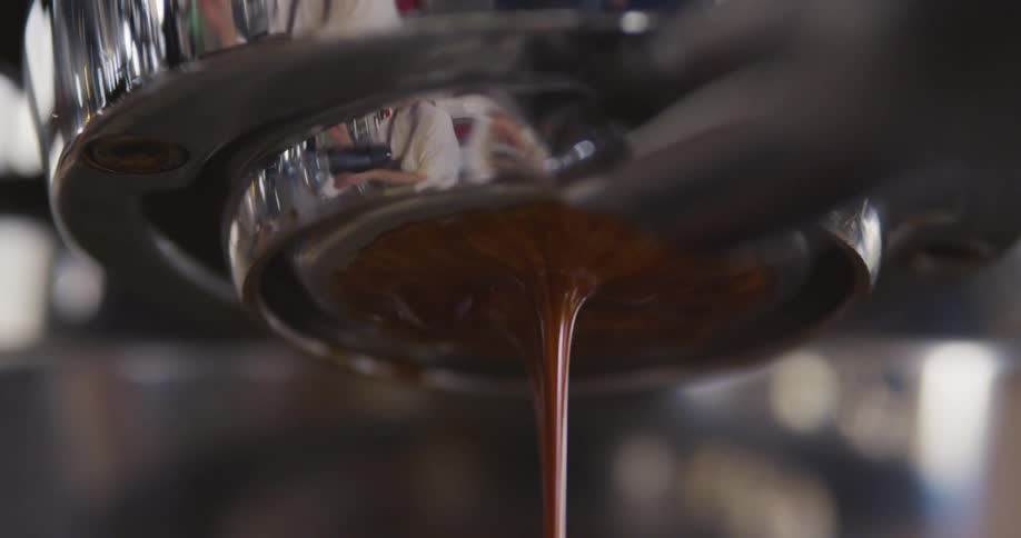 Coffee liquid is pouring out of an appliance
