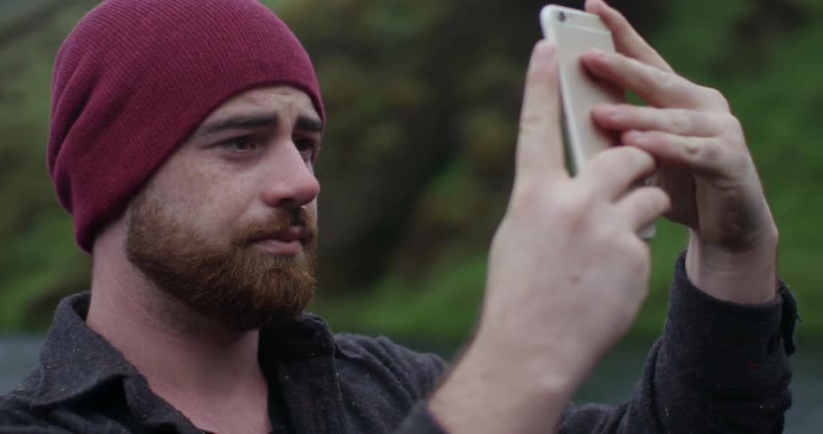 A man is taking a photo with his phone