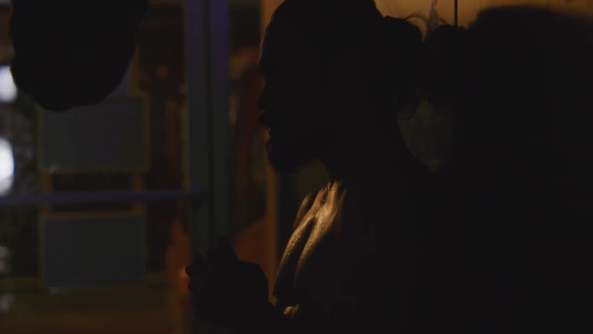 A portrait of a man standing outside at night